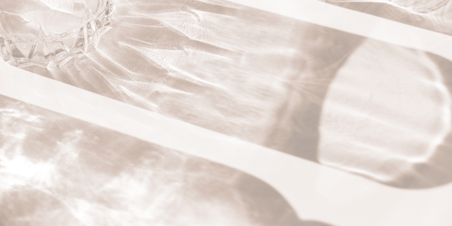 Glass casting shadows on a textured surface.